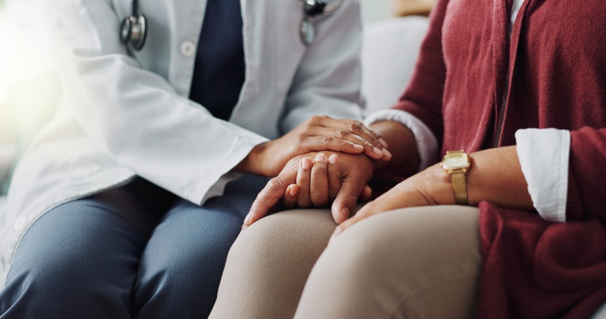 Closeup, hands or care as doctor, patient or healthcare consultation to trust, support or help. People, lab coat or touch as hope, faith or prayer in medical appointment to discuss retirement health.